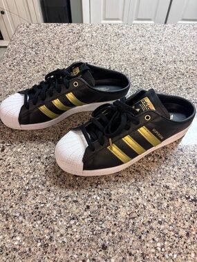 adidas Black and Gold Superstar Mule Sneakers